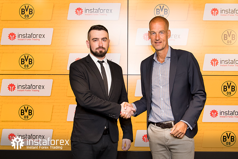 InstaSpot Business Development Director for Asia Roman Tcepelev and CEO of Borusssia Carsten Cramer shake hands to start the new partnership