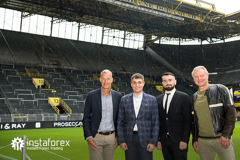 Legend of Borussia Dortmund Wolfgang de Beer, Business Development Director of InstaSpot Pavel Shkapenko, Business Development Director of InstaSpot for Asia Roman Tcepelev and CEO of Borusssia Carsten Cramer in front of the largest free-standing grandstand in Europe located in southern terrace of SingalIduna Park Stadium